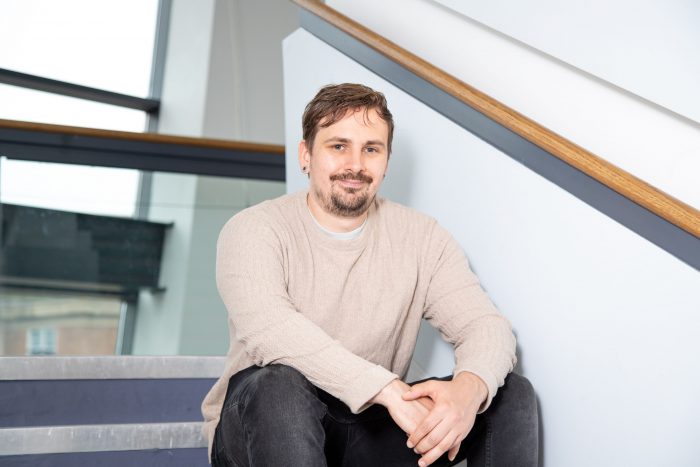 Smiling student sat on steps